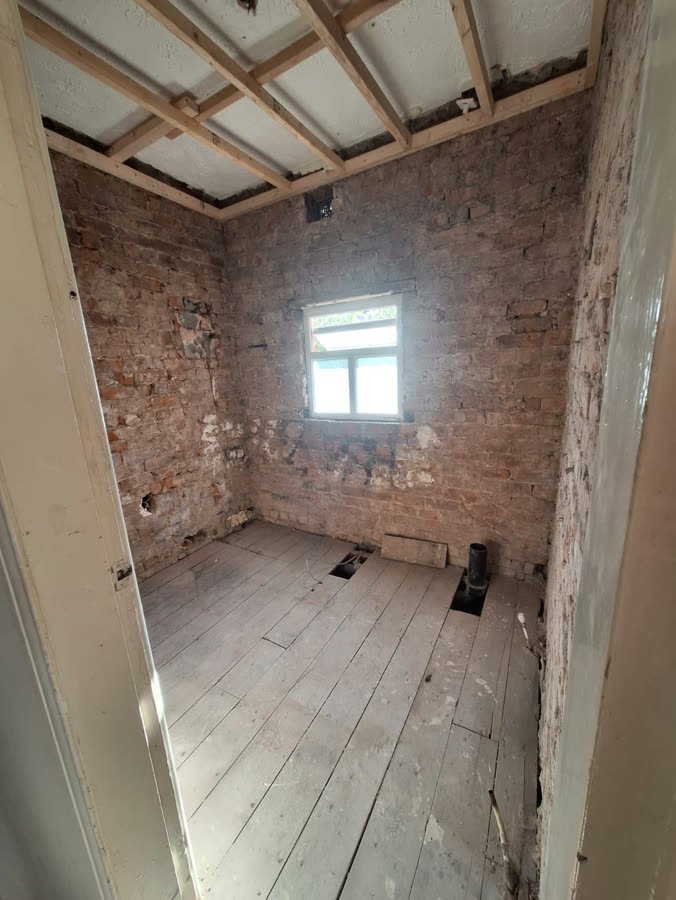 Walls taken back to exposed brick